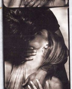 an old photo of two women kissing each other in front of a man's face