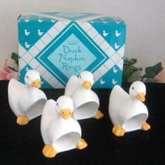 four duck napkin rings sitting on top of a table next to a box of tissues