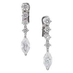 Round and marquise diamond dangle drop earrings in 18k white gold. EGL Certified 2 marquise cut diamonds F-G SI I, approx. 2.20tcw EGL Certificate #US400132122D 8 round brilliant cut diamonds G VS-SI, approx. .90cts 18k white gold Stamped: 18k 5.4 grams Top to bottom: 30.0mm 1 3/16 Inch Width: 5.15mm or 3/16 Inch Depth or thickness: 3.6mm Diamond Marquise Bridal Earrings For Formal Occasions, Formal Diamond Marquise Bridal Earrings, Luxury Marquise Diamond Earrings For Formal Occasions, Fine Jewelry Bridal Earrings With Marquise Brilliant Cut, Marquise Brilliant Cut White Gold Bridal Earrings, White Gold Marquise Bridal Earrings With Brilliant Cut, Formal Marquise Bridal Earrings With Diamond Accents, Luxury Marquise Brilliant Cut Bridal Earrings, Luxury Marquise Cut Diamond Earrings For Formal Events