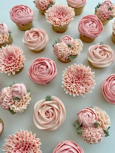 cupcakes with pink frosting and flowers on them are arranged in a circle