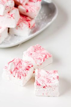 white and red marshmallows on a plate