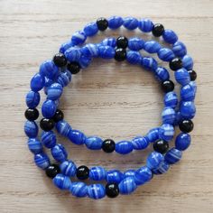 Set of three blue and black glass bead stretch bracelets.  7 1/2 inches Blue beads are a beautiful swirl pattern and black beads are solid black. All bracelets are shipped in organza drawstring bags and boxed. Ships in 1-2 days Bead Stretch Bracelets, Drawstring Bags, Swirl Pattern, Beaded Stretch Bracelet, Blue And Black, Blue Beads, Black Stretch, Black Glass, Stretch Bracelet