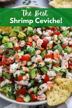 a bowl full of shrimp salad with tortilla chips