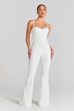 Hailey White Jumpsuit Women's Clothing > Jumpsuits. DESCRIPTION &  FEATURES  HAILEY WHITE is the perfect piece for those daring to make a statement at their bridal shower or rehearsal dinner. A figure-hugging jumpsuit complete with a flared trouser fit for a modern bride. The perfect one-piece for your party celebrations.   Crafted from shimmering velvet fabric covered in delicate, hand embroidered sequins and metallic thread embroidery. A fully detailed piece which creates a high impact look, c White Jumpsuit Wedding, Nadine Merabi, Structured Corset, Wedding Jumpsuit, Flare Jumpsuit, Fitted Jumpsuit, Flared Trousers, White Velvet, White Jumpsuit