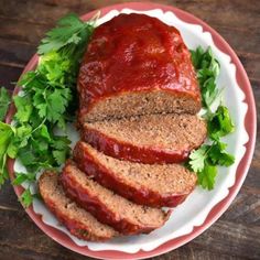 sliced meatloaf on a plate with lettuce and garnishes