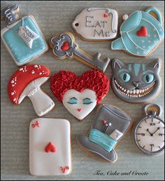 decorated cookies are arranged in the shape of heart, cat, clock and other items