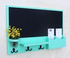 a chalkboard and some flowers on a shelf