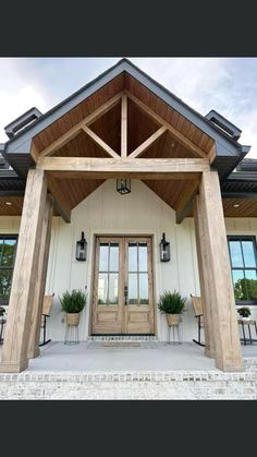 the front entrance to a house with two doors and windows