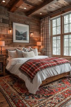 a bedroom with wood paneled walls and a large bed in the middle of it