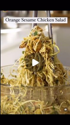 an orange sesame chicken salad in a glass bowl on a table with the words orange sesame chicken salad