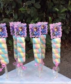 there are three candy sticks with princesses on them in the shape of lollipops