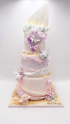 a three tiered cake decorated with flowers and birds