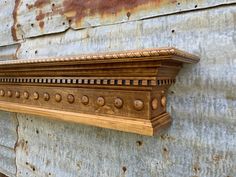 an old wooden shelf on the side of a building