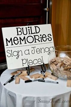 a sign that says build memories on top of a table covered in clothes pegs