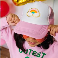 Product Details The Rainbow Patch Hat for kids is a fun and festive accessory for celebrating any day! Pink/White rainbow patch, multicolor chenille with gold glitter outline Material Foam/Mesh Each hat is hand pressed with love Fit Adjustable snap back closure fits 45-56cm Size: Recommended for ages 4+ Care Spot clean Playful White Trucker Hat For Spring, Fun Pink Hats For Playtime, Playful Snapback Hat For Playtime, Fun Pink Trucker Hat For Birthday, Playful White Snapback Trucker Hat, Fun Snapback Hats For Playtime, Whimsical Adjustable Hats For Playtime, Playful White Trucker Hat, Adjustable Whimsical Hats For Playtime