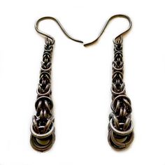 In stock and ready to ship (free!) next business day. Drawing from techniques used in ancient armor, fine metalwork and jewelry, these earrings add a modern, sophisticated touch to a beautiful, ancient art form; flowing down with clean visual form while displaying increasing complexity as you draw near. Nickel Free Lead Free Low Copper Hypo-allergenic 100% Recycled Silver Handmade in our studio to your specifications, one ring at a time. These earrings are oxidized to a warm gray to brown finish Medieval Style Silver Earrings For Gift, Silver Byzantine Pierced Earrings, Silver Round Byzantine Earrings, Medieval Style Nickel-free Silver Earrings, Medieval Style Handmade Earrings For Gift, Handmade Medieval Metal Earrings, Medieval Handmade Metal Earrings, Byzantine Jewelry, Ancient Armor