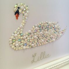 a swan made out of pearls and beads