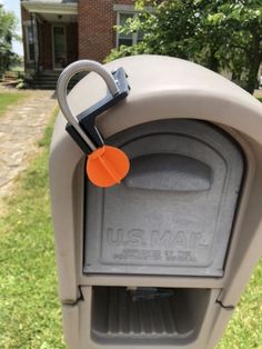 a mailbox with an orange tag attached to it