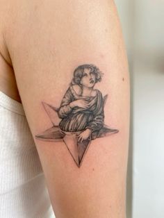 a woman with a tattoo on her arm is sitting in the middle of a triangle