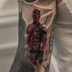 a man with a deadpool tattoo on his arm