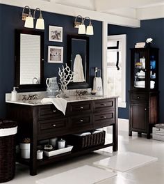 a bathroom with blue walls and white tile on the floor, two sinks are shown