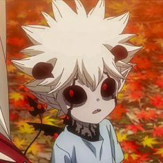 an anime character with white hair and black eyes standing in front of autumn leaves on the ground