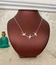 This is such a cute necklace with three little birds flying together in a row.The Swallows are silver-plated measuring 18mm (0.72in) each and are hung on a delicate silver-plated chain which measures 16 inches but I can adjust the length free of charge. Just write a message in the "Message to seller" box when checking out.Comes with left or right facing birds.Comes in a black velvet cushioned box as seen in last photo.INTERNATIONAL BUYERS please choose the tracking option if you would like your Silver Bird Necklace, Flying Together, Gold Sun, Swallows, Cute Necklace, Little Birds, Lovely Earrings, Birds Flying, Velvet Cushions