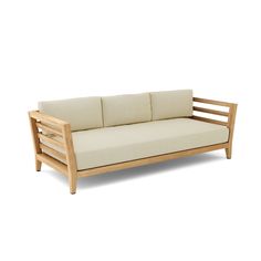 a wooden couch with white cushions on it