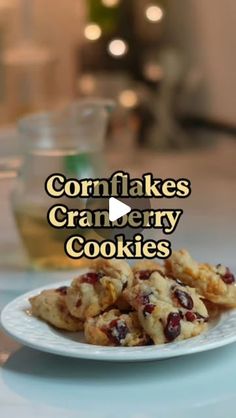 cookies on a plate with the words cornflakes cranberry cookies in front of them