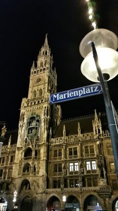 a street sign in front of a large building