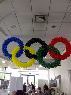 the olympic rings are hanging from the ceiling