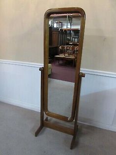 a large mirror sitting on top of a wooden stand