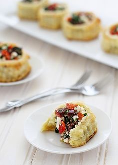 small appetizers on white plates next to silverware