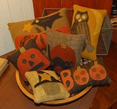 a bowl filled with lots of pillows on top of a wooden table