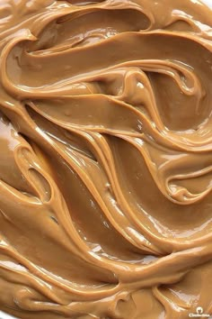 a bowl filled with chocolate frosting sitting on top of a table