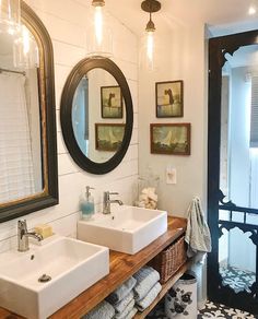 a bathroom with two sinks and mirrors on the wall