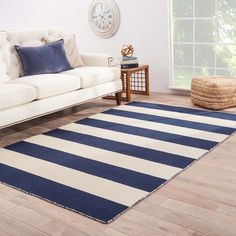 a blue and white striped rug in a living room