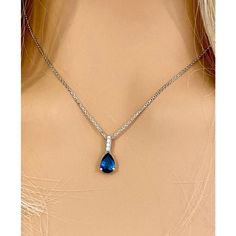 Fourteen karats white gold sapphire and diamond necklace pendant Trending style of layers on layers of gold chains to chunky, retro pendants paired with dainty chokers, layering your necklaces has become an art Necklace measuring 16 inches long Diamond bail hanging pendant 0.35" long with pear shaped sapphire drop Pear Shaped blue sapphire weighing 1.15 carats Sapphire is of royal blue hue Diamond bail weighing 0.10 carats Oval cable chain necklace with spring lock New Necklace Handmade in the USA Some gemstones are very hard to match. The gems that exude subtle color variations are very tough candidates due to color zoning, clarity, and measurements. Our collections challenge our teams in both creativity and know-how.  From the initial drawings through to stone setting and the final polis Sapphire Pendant With Diamond Cut, Teardrop Sapphire Necklace In Fine Jewelry Style, Sapphire Teardrop Pendant Necklace In Sterling Silver, Elegant Blue Diamond Pendant Necklace, Diamond Teardrop Pendant Necklace With Polished Finish, Elegant Blue Chain Necklace, Sapphire Jewelry With Diamond Cut Round Pendant, Sapphire Necklace With Diamond Cut Round Pendant, Sapphire Round Pendant Necklace With Diamond Cut