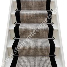 an image of stairs with black and white carpet on the bottom, and two sides