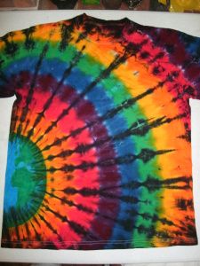 a tie dyed t - shirt sitting on top of a table