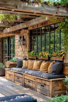 a wooden bench sitting on top of a wooden floor next to a window filled with potted plants