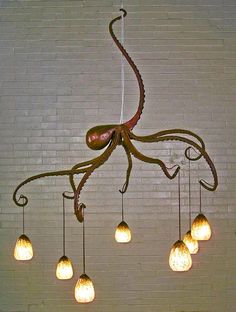 an octopus chandelier hanging from the ceiling with five bulbs on each light fixture