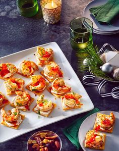 small appetizers are arranged on a white platter