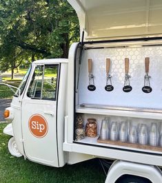 an old white truck with cups and utensils in the back