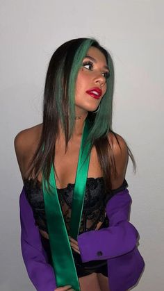 a woman with green hair is wearing a purple jacket and green ribbon around her neck