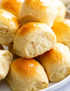 a white plate filled with rolls on top of a table