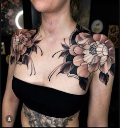 a woman with tattoos on her chest and shoulder