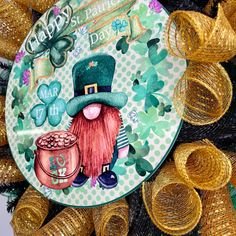 a st patrick's day plate is on top of some gold foiled streamers