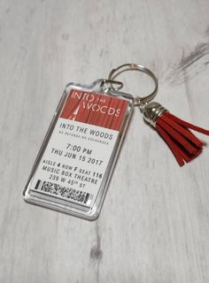 a keychain with a ticket for into the woods