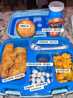 a blue lunch box filled with food on top of a table